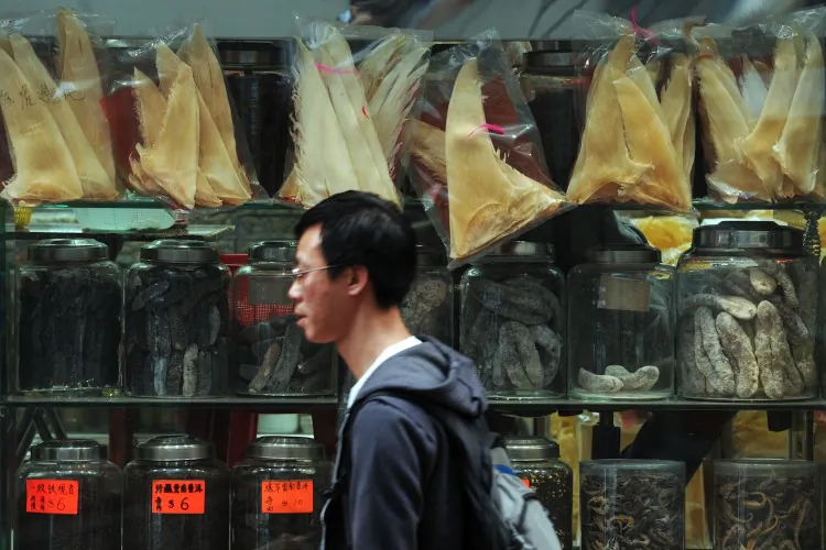 A man walking by a store selling shark fins in Hong Kong. Cathay Pacific said on September 5, 2012 it would no longer carry unsustainably sourced shark products on its cargo flights, dealing a blow to Hong Kong's huge shark fin industry. (Aaron Tam/AFP/GettyImages)