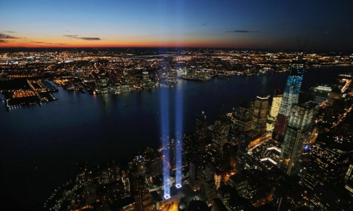 The ‘Tribute in Light’ shines as One World Trade Center (R) rises under construction on the eleventh anniversary of the terrorist attacks on lower Manhattan at the World Trade Center on September 11, 2012 in New York City. (Mario Tama/Getty Images)