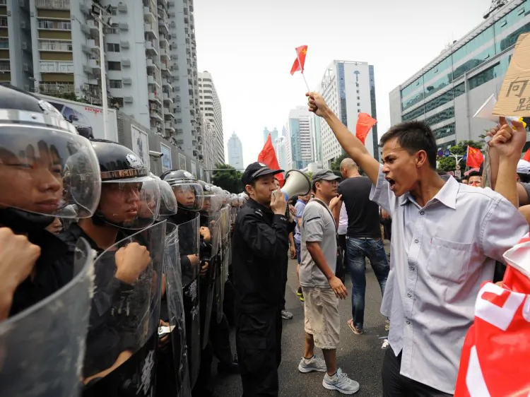 A line of riot police stand firm against anti-Japan protesters during a protest over the Diaoyu islands issue, known as the Senkaku islands in Japan, in the southern Chinese city of Shenzhen on Sept. 18, 2012. (Peter Parks/AFP/Getty Images)