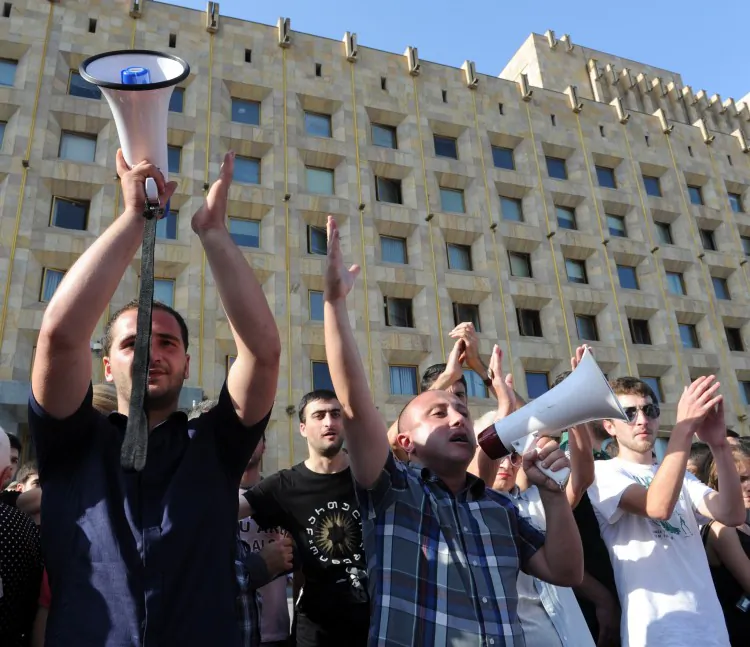 People shout on Sept. 19, 2012 during a protest against torture in prisons, blocking one of the main streets in Tbilisi, Georgia. (Vano Shlamov/AFP/GettyImages)