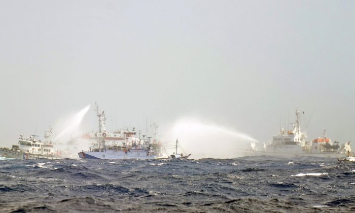Japanese and Taiwan Coast Guard vessels use water cannons as they clash near the disputed Diaoyu/Senkaku islands in territorial waters in the East China Sea on Sept. 25, 2012. Military spending has outpaced strategy and the new status has given those in the armed forces a confidence that does not bode well for the region. (Sam Yeh/AFP/Getty Images)