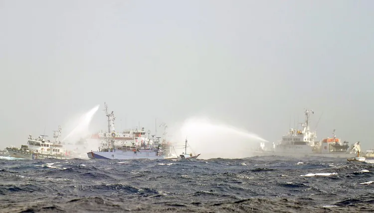 Japanese and Taiwan Coast Guard vessels use water cannons as they clash near the disputed Diaoyu/Senkaku islands in territorial waters in the East China Sea on Sept. 25, 2012. Military spending has outpaced strategy and the new status has given those in the armed forces a confidence that does not bode well for the region. (Sam Yeh/AFP/Getty Images)