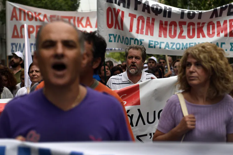 Health workers protest outside the Health Ministry in Athens, Greece, Oct. 4, against the latest round of austerity measures, which the government is negotiating with its creditors: the EU, the IMF and ECB. The ECB left interest rates unchanged yesterday and signaled it is ready to bail out Italy and Spain, but that would also be contingent on Greek-like austerity measures. (Aris Messinis/AFP/GettyImages)