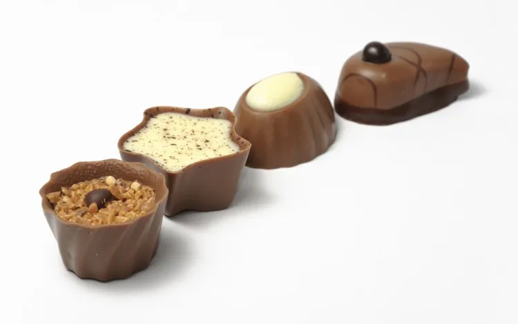 First pop what you want to appear on the top of your chocolate into the bottom of your mould. When it is turned out, it will be on top. (MatteoCozzi/Photos.com)