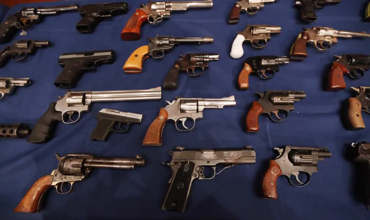 Illegal firearms, which were seized in a weapons bust in East Harlem, New York, in 2012, are displayed on a table. (Mario Tama/Getty Images)