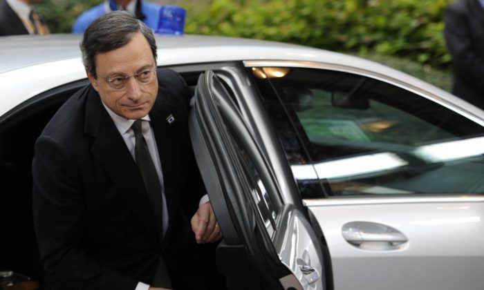 European Central Bank President Mario Draghi (L) arrives for an EU summit in Brussels last Thursday, Oct. 18. It was the first of three summits before Christmas, which EU leaders hope would strengthen the bloc's foundations. (John Tthys/AFP/Getty Images)