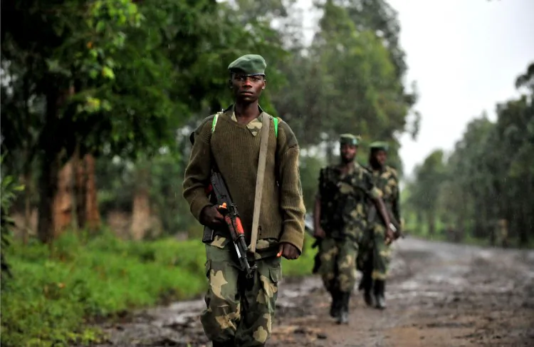 M23 rebel group soldiers patrol on Oct. 17, 2012 in Rangira, near Rutshuru, Democratic Republic of the Congo. The rebel movement is fighting the Congolese army for control of parts of the North Kivu Province, which has an abundance of gold, timber, and other minerals. (Junior D. Kannah/AFP/GettyImages)