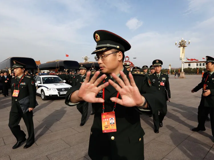 A soldier tries to prevent photos being taken at Tiananmen Square on Nov. 7, in Beijing. The 18th National Congress of the Chinese Communist Party will be held from Nov. 8 to Nov. 14, when a new set of leaders will be sworn in. (Lintao Zhang/Getty Images)