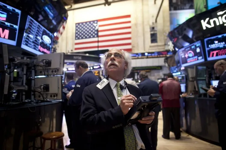 Traders work on the floor of the New York Stock Exchange, Nov. 7, the day after President Barack Obama won re-election. The Dow Jones fell 313 points, or 2.4 percent.(Allison Joyce/Getty Images)