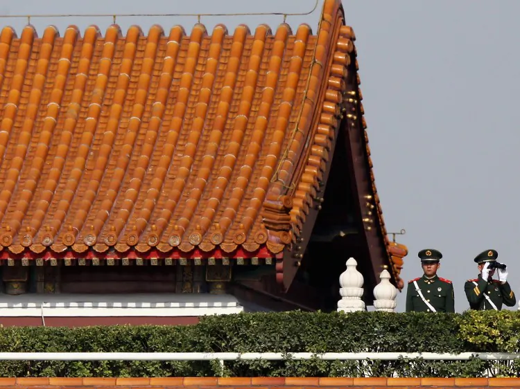 Chinese paramilitary policemen monitor the square with telescope on the Tiananmen Gate during the opening session, on Nov. 8, 2012 in Beijing. Cao Shunli has always been concerned about China’s human rights situation. (Feng Li/Getty Images)