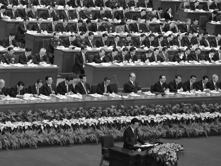 A delegate speaks on a mobile as he attends the fourth plenary session of the National People's Congress, on March 13, 2007, in Beijing. (Guang Niu/Getty Images)