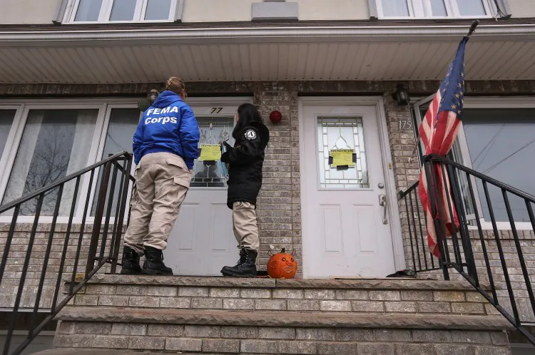 Workers from FEMA go door to door in the Midland Beach area on Staten Island, New York City, Nov. 13 . The agency has set up disaster recovery centers in the area to aid people affected by superstorm Sandy. (John Moore/Getty Images)
