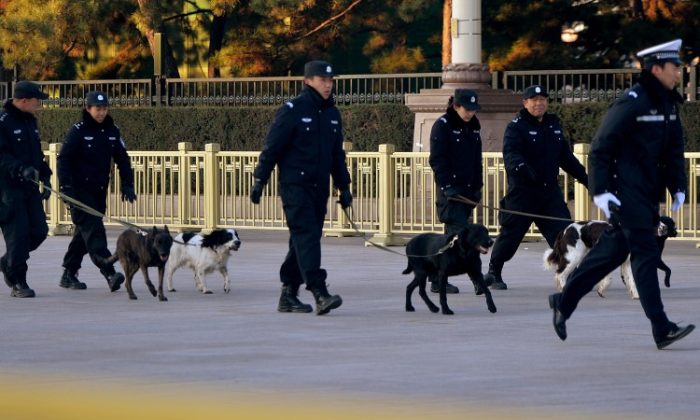 A police squad with dogs enforces security during the closing of the recently-concluded 18th Party Congress. Liberals scholars in China have called for the abolishment of the Communist Party committee that oversees the police and all law enforcement in China. (Mark Ralston/AFP/Getty Images)
