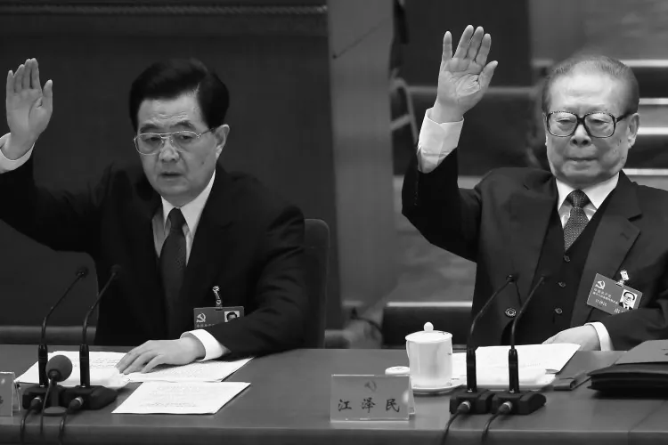 Outgoing Communist Party head Hu Jintao (L) and former Party head Jiang Zemin (R) raise their hands as they take a vote during the closing session of the 18th Party Congress on Nov. 14, 2012 in Beijing, China. New Party leaders were introduced the next day. (Feng Li/Getty Images)