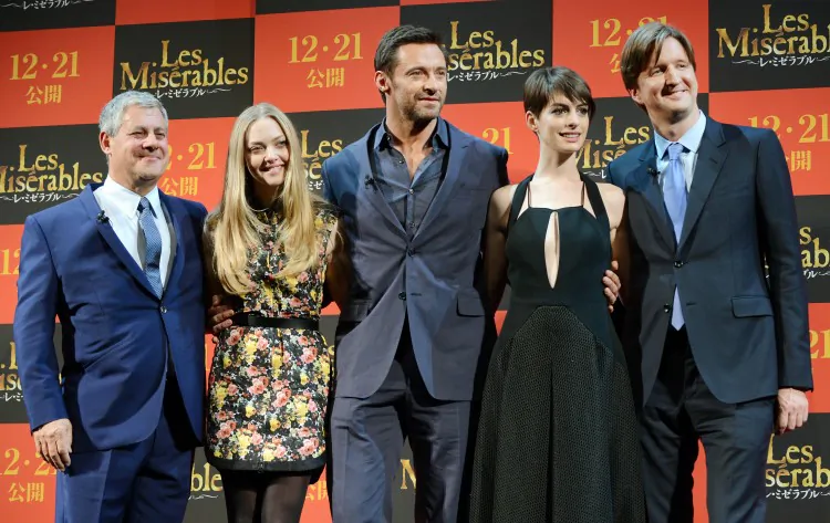 (L-R) Producer Cameron Mackintosh, actress Amanda Seyfreid, actor Hugh Jackman, actress Anne Hathaway and director Tom Hooper pose for photographers during an event to promote 'Les Miserables' in Tokyo on Nov. 28, 2012. (TORU YAMANAKA/AFP/Getty Images)
