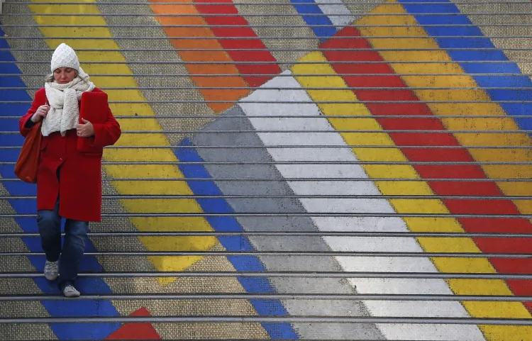 A woman walks down the colored steps of the Albertina museum on a cold day in Vienna on Dec. 3. (Alexander Klein/AFP/Getty Images)