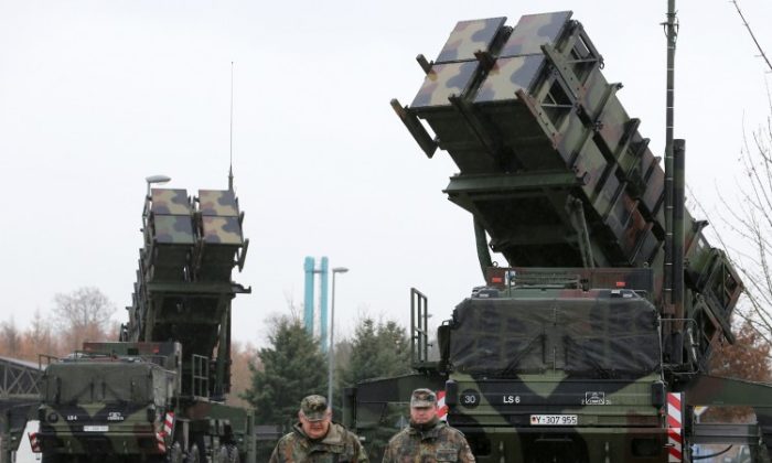 Soldiers of the Air Defence Missile Squadron 2 walk past Patriot missile launchers in the background in Bad Suelze, northern Germany on Dec. 4, 2012. (Bernd Wustneck/AFP/Getty Images)