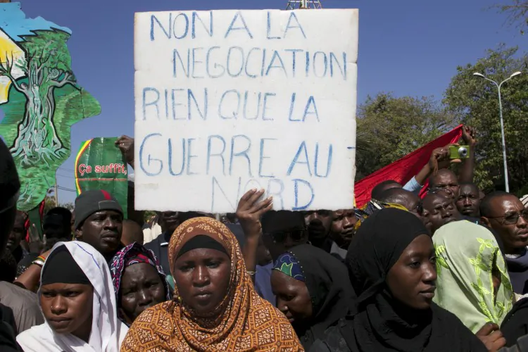 A man holds a banner that reads 'No to negotiation, only war in the north' as thousands of Malians gather in Mali's capital, Bamako, on Dec. 8, 2012. Malians are divided—some call for foreign military intervention to reclaim the north, controlled for eight months by Islamist armed groups, while some fear intervention could bring a new bout of tension and a new humanitarian crisis. (HABIBOU KOUYATE/AFP/Getty Images)