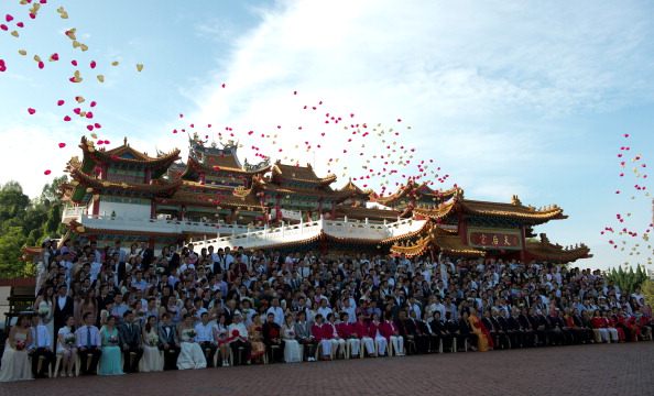 Ballons fly in air as newlywed couples celebrate their mass wedding in conjunction with the date 12.12.12 outside a Chinese temple in Kuala Lumpur on Dec. 12, 2012. (Saeed Khan/AFP/Getty Images)