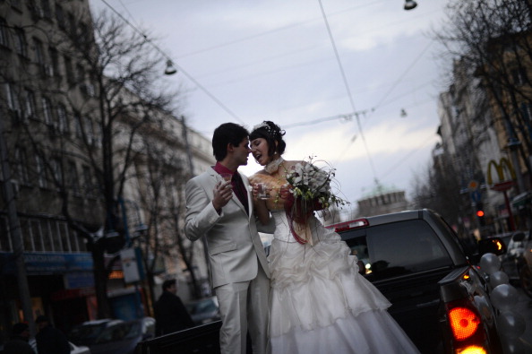 A Bulgarian couple dance on a car just before their wedding ceremony in Sofia on Dec. 12, 2012.  (Dimitar Dilkoff/AFP/Getty Images)
