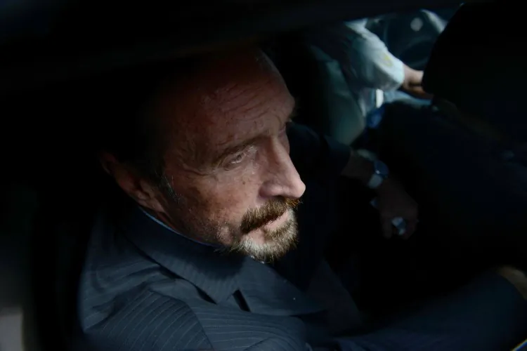 US anti-virus software pioneer John McAfee is transferred in a migration's car to the Aurora international airport in Guatemala City on Dec. 12, 2012. (Johan Ordonez/AFP/Getty Images)