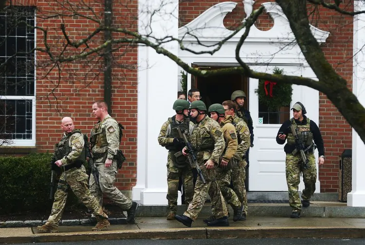 Connecticut State Police officers walk out of St. Rose of Lima Roman Catholic Church after a threat to the church was received following the mass shooting at Sandy Hook Elementary School on Dec. 16, 2012, in Newtown, Conn. (Mario Tama/Getty Images)