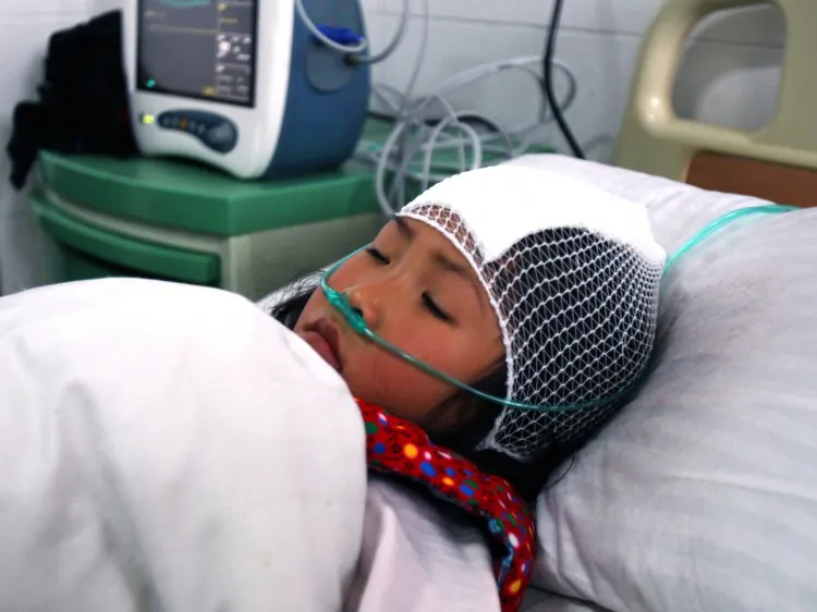 A girl lying on a hospital bed after she was stabbed during a knife attack that took place, on Dec. 14, at a primary school in Guangshan county, central China's Henan Province. (STR/AFP/Getty Images)