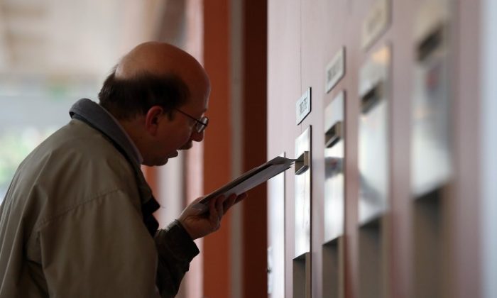 A customer drops letters into a mailbox at the United States Post Office on Dec. 17, 2012, in San Francisco, Calif. 2012 saw another difficult year financially for the United States Postal Service. (Justin Sullivan/Getty Images)