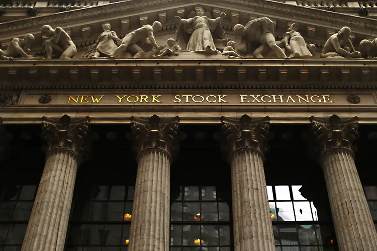 The iconic facade of the New York Stock Exchange (NYSE) is viewed on Dec. 20 in lower Manhattan. NYSE has agreed to an $8.2 billion takeover from Atlanta-based energy trader Intercontinental Exchange (ICE). (Spencer Platt/Getty Images)