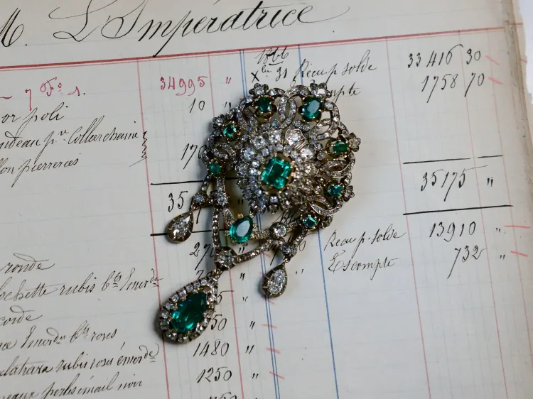 A picture taken on December 18, 2012 shows a corsage pin made of emeralds, diamonds, silver and gold, displayed on a 1867 page order of Empress Eugenie, the wife of Napoleon III, Emperor of the French, in the Mellerio jewelry store in Paris. (Franck Fife/AFP/Getty Images)