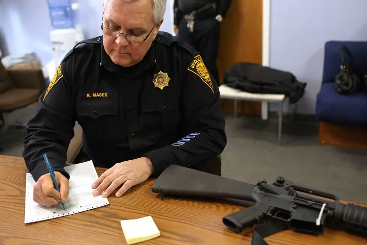 Lt. Ray Mesek registers a Colt AR-15 at a gun buyback event at the Bridgeport Police Department's Community Services Division on Dec. 22 in Bridgeport, Connecticut. The recent massacre at Newtown, Conn. has flamed talks of gun-control, while manufacturers report that gun sales are surging to new records. (Spencer Platt/Getty Images)