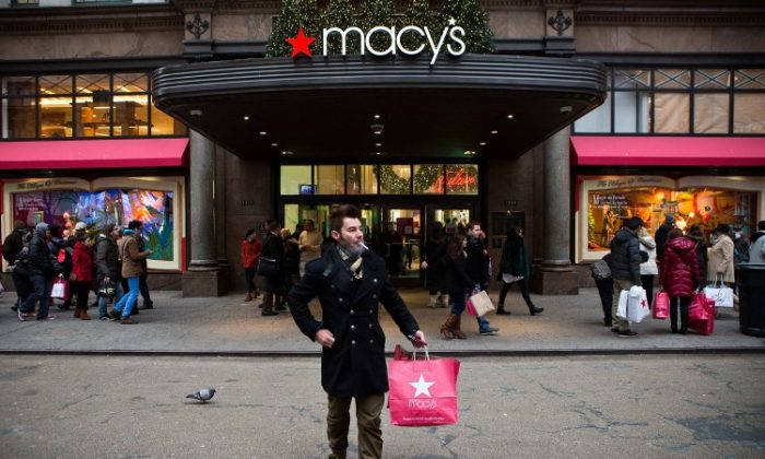 A shopper exits Macy's department store in Herald Square on Dec. 26 in New York City. (Andrew Burton/Getty Images)