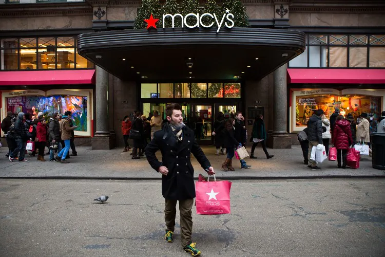 A shopper exits Macy's department store in Herald Square on Dec. 26 in New York City. (Andrew Burton/Getty Images)