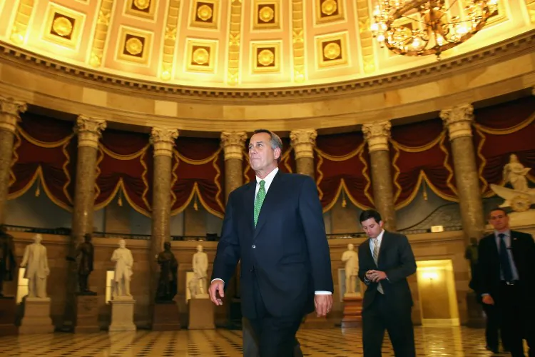 Speaker of the House John Boehner (R-Ohio) walks through Statuary Hall before entering the House Chamber to oversee a vote on "fiscal cliff" legislation during a rare New Year's Day session Jan. 1, 2013, in Washington, D.C. The House passed the bill 257-167, thus postponing a wide range of federal spending cuts. (Chip Somodevilla/Getty Images)