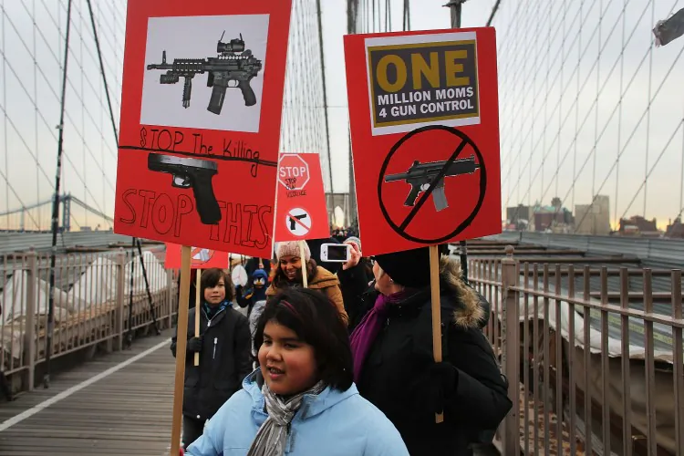 Participants with One Million Moms for Gun Control, a gun control group formed in the wake of the massacre at a Newtown, Connecticut elementary school, attend a rally and march across the Brooklyn Bridge on January 21 in New York City. (Spencer Platt/Getty Images)