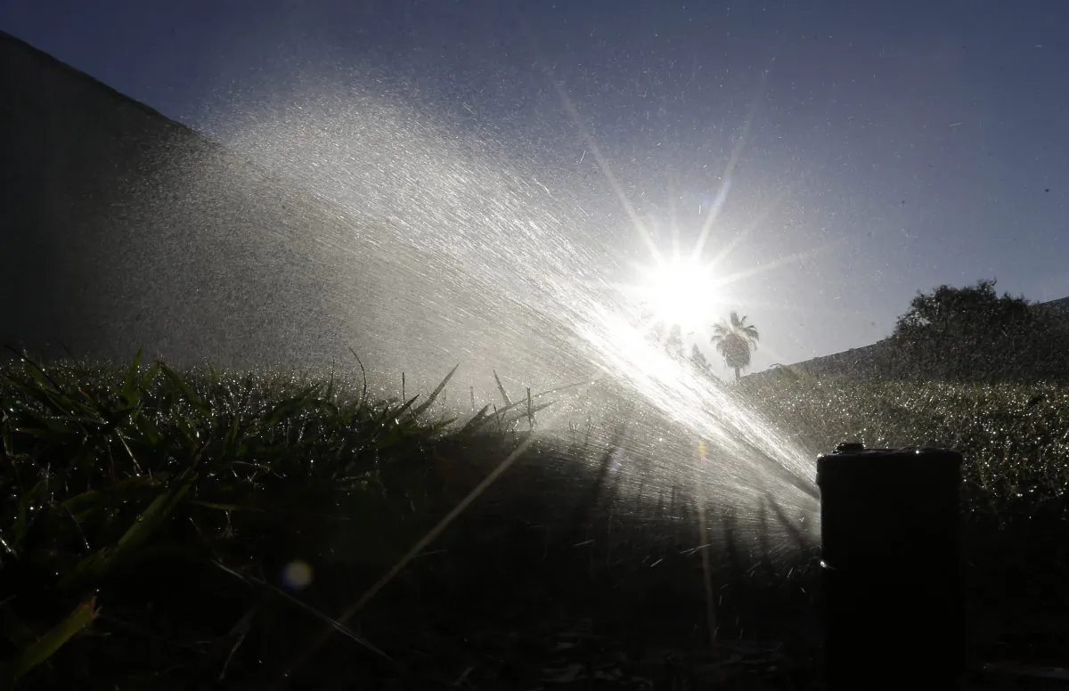 In this June 23, 2015, file photo a lawn is irrigated in Sacramento, Calif. (AP Photo/Rich Pedroncelli)