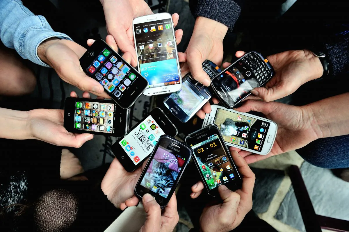 People show their smartphones on December 25, 2013 in Dinan, northwestern France. (Philippe Huguen/AFP/Getty Images)