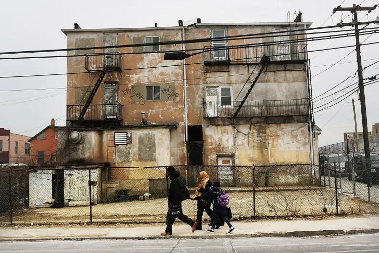 A family walks down a street in the Rockaways following Hurricane Sandy on Jan. 25, 2013 in New York City. (Spencer Platt/Getty Images)