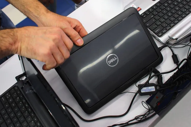 A customer looks at a Dell computer on display at the Electric Avenue store in Miami, Fla., Feb. 5. Dell Inc. announced it will be acquired by CEO and founder Michael Dell for $24.4 billion. (Joe Raedle/Getty Images)