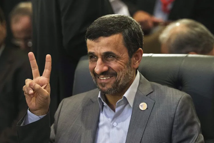 Iranian President Mahmoud Ahmadinejad flashes the victory sign as he attends the 12th summit of the Organisation of Islamic Cooperation on Feb. 6, 2013 in Cairo. (Gianliugi Guercia/AFP/Getty Images)