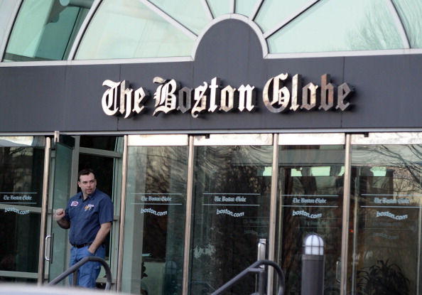 A man walks out of The Boston Globe on Feb. 20, 2013 in Boston, Massachusetts the same day The New York Times Company, which owns the paper, said it plans to sell the Globe and its New England Media Group. (Darren McCollester/Getty Images)