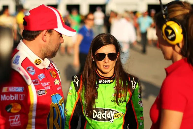 Danica Patrick, driver of the #34 GoDaddy.com Chevrolet, speaks with Tony Stewart, driver of the #33 Oreo/Ritz Chevrolet, during qualifying for the NASCAR Nationwide Series DRIVE4COPD 300 at Daytona International Speedway on Feb. 22, 2013 in Daytona Beach, Florida. (Mike Ehrmann/Getty Images)