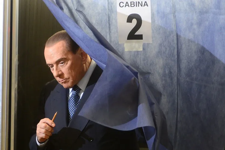 Italian former Prime Minister Silvio Berlusconi leaves the voting booth before casting his ballot at a polling station on Feb. 24, 2013 in Milan. (Olivier Morin/AFP/Getty Images)