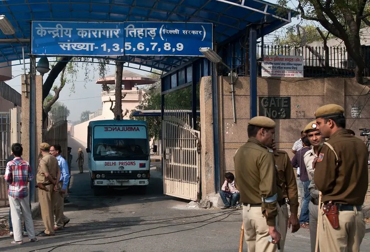 Indian policemen stand guard as an ambulance leaves the main entrance of Tihar Jail in New Delhi on March 11, 2013. (Manan Vatsyayana/AFP/Getty Images)