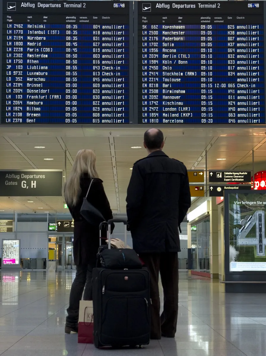 Passengers in this file photo wait in front of the destination board which shows cancelled flights. Being organized for your next flight can make the trip more relaxing. (Christof Stache/AFP/Getty Images)