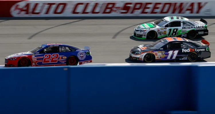 Joey Logano, driver of the #22 AAA Southern California Ford, leads Denny Hamlin, driver of the #11 FedEx Express Toyota, and Kyle Busch, driver of the #18 Interstate Batteries Toyota, during the NASCAR Sprint Cup Series Auto Club 400 at Auto Club Speedway on March 24, 2013 in Fontana, Calif. (Chris Graythen/Getty Images)