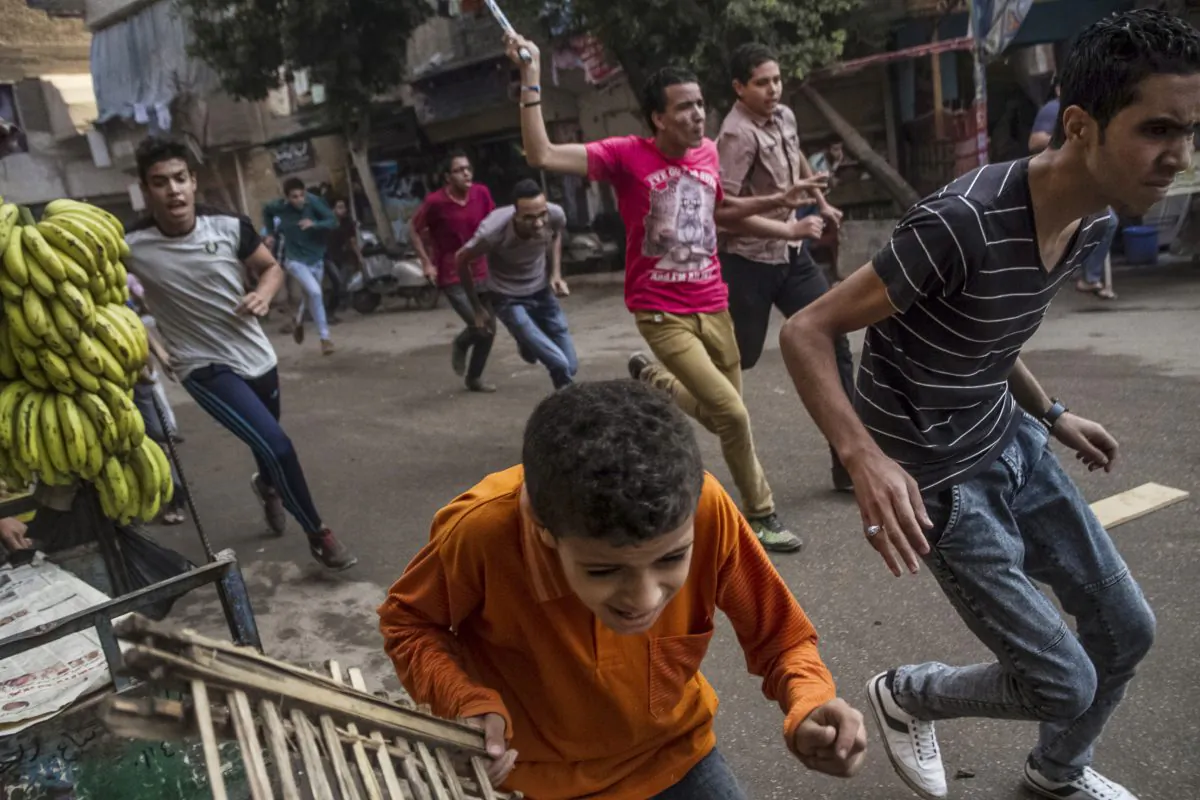 Supporters of the Muslim Brotherhood and bystanders run away from Egyptian security forces during clashes following their protest in the Matariya district of Cairo, Egypt on Tuesday, June 30, 2015. (AP Photo/Belal Darder)