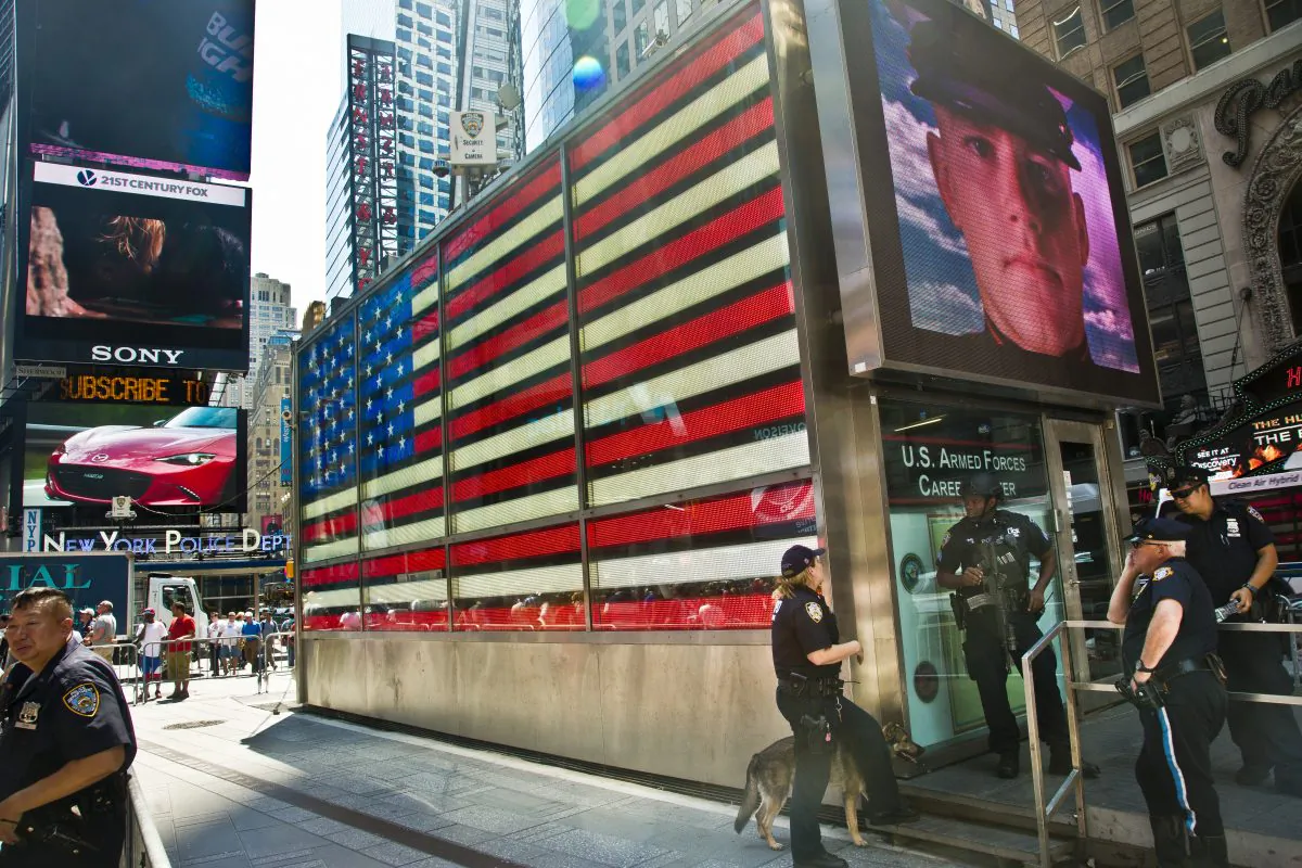 Officers with the NYPD anti-terrorism unit guard a military recruiting station in Times Square, New York, on July 17, 2015. (AP Photo/Bebeto Matthews)