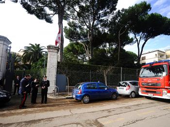 Italian Carabinieri and firemen stand in front of the Swiss embassy in Rome on December 23, 2010 after parcel bomb exploded. (Filippo Monteforte/AFP/Getty Images)
