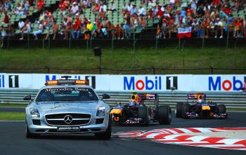 The safety Car leads Red Bull's Mark Webber and Sebastian Vettel around the Hungaroring circuit during the Formula One Hungarian Grand Prix. (Dimitar Dilkoff/AFP/Getty Images)